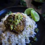 beef short rib with chimichurri sauce on rice with limes