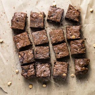 sliced brownies dusted with powdered sugar on paper