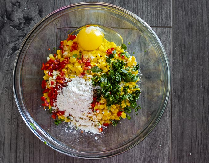 corn, flour, eggs, and seasonings in a bowl.