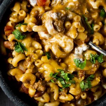 macaroni and meat sauce with cheese in a bowl with cilantro