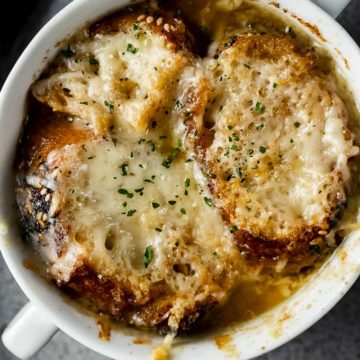 bowl of soup with bread and cheese on top