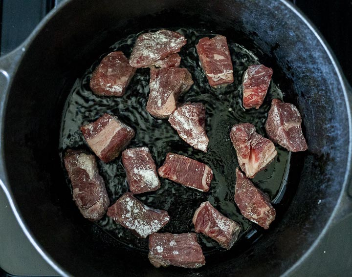 raw beef cooking in a pot