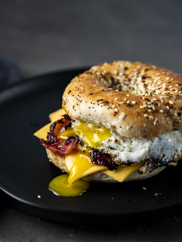 bacon egg and cheese bagel sandwich on a plate