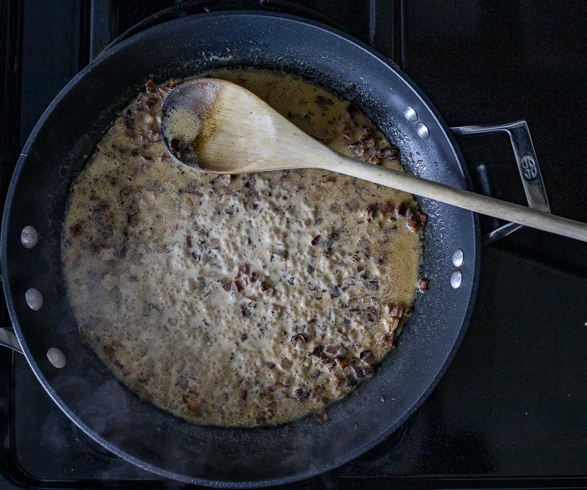 creamy sauce cooking in a skillet.