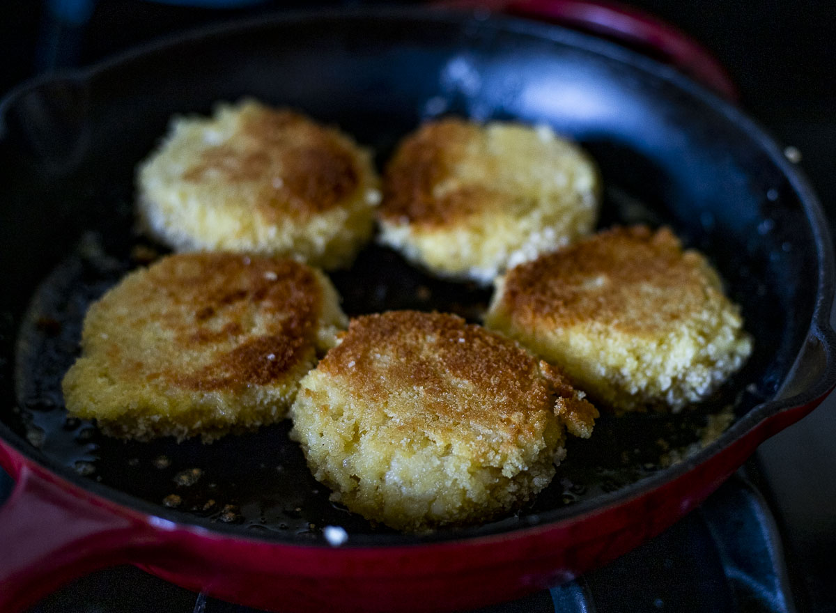 browned risotto cakes in a skillet.