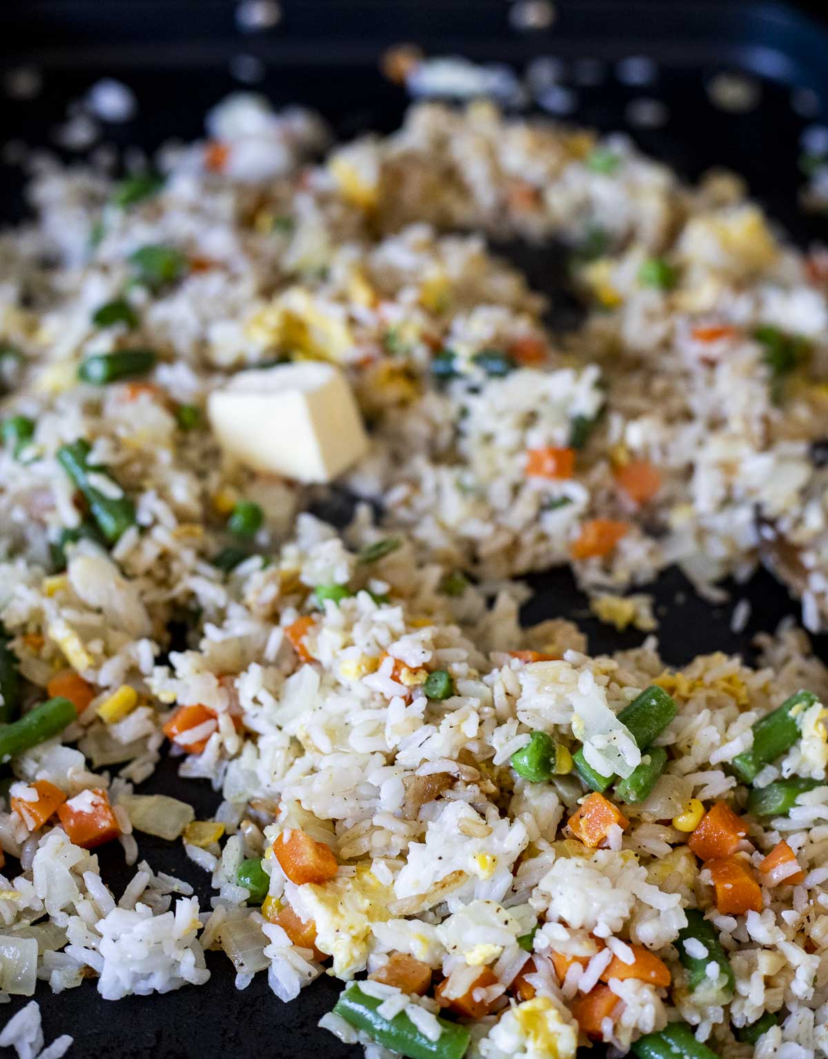 fried rice with butter being added.