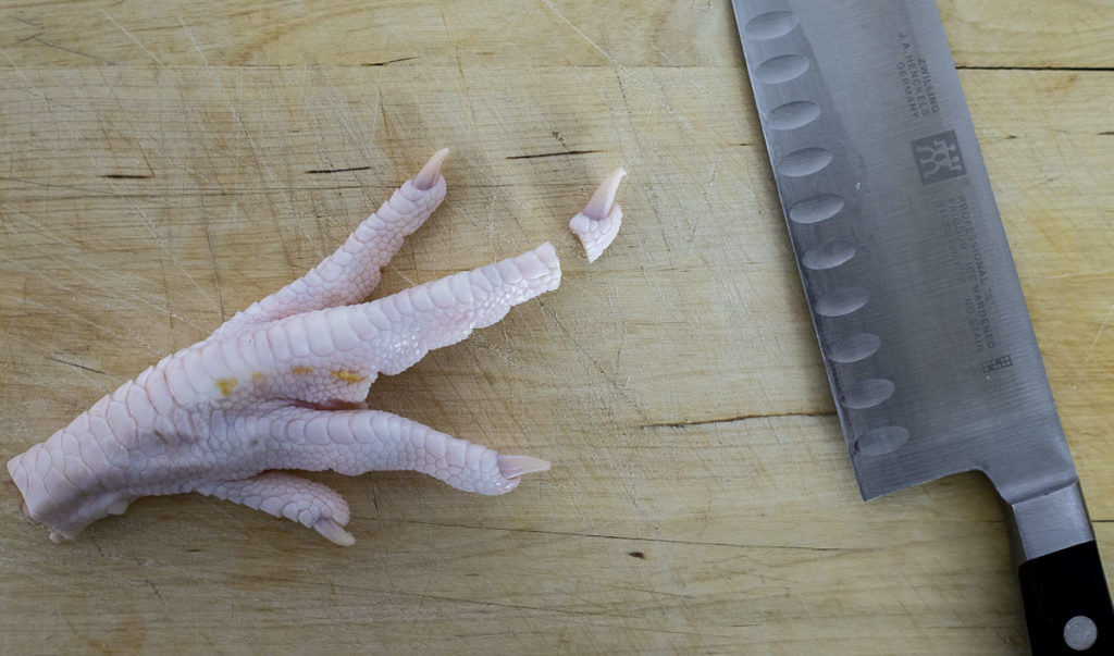 a chicken foot with the nail cut off and a knife on the side