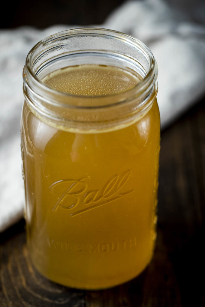 a glass jar of golden liquid