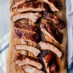 ribs on a cutting board with a knife