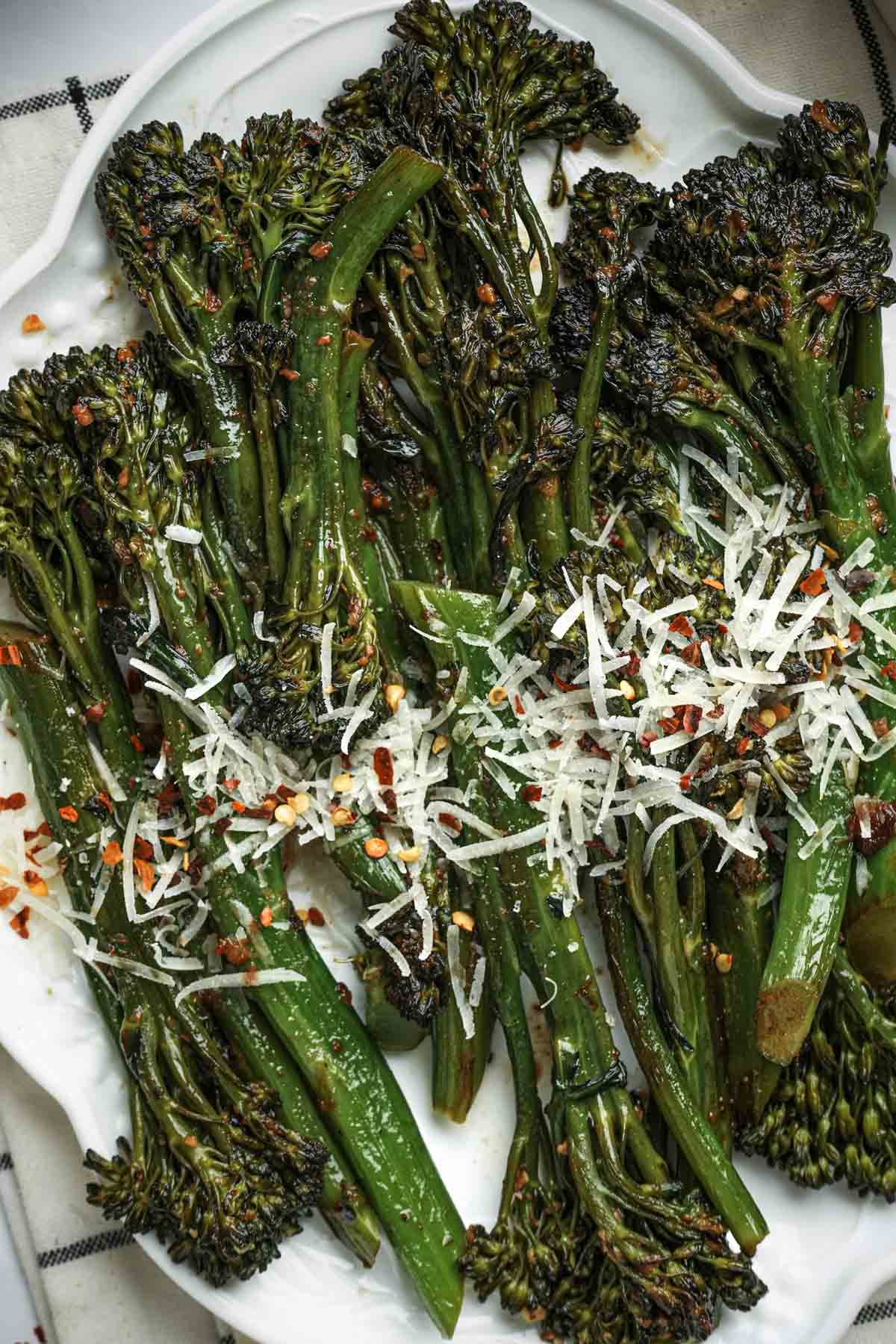 cooked broccolini sprinkled with cheese and red pepper