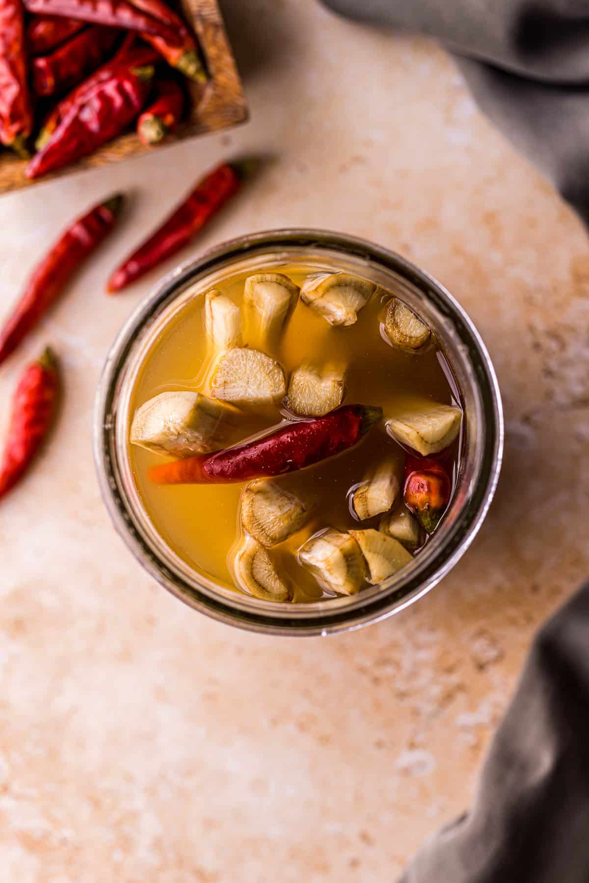 a jar of sliced burdock root and chilies in liquid