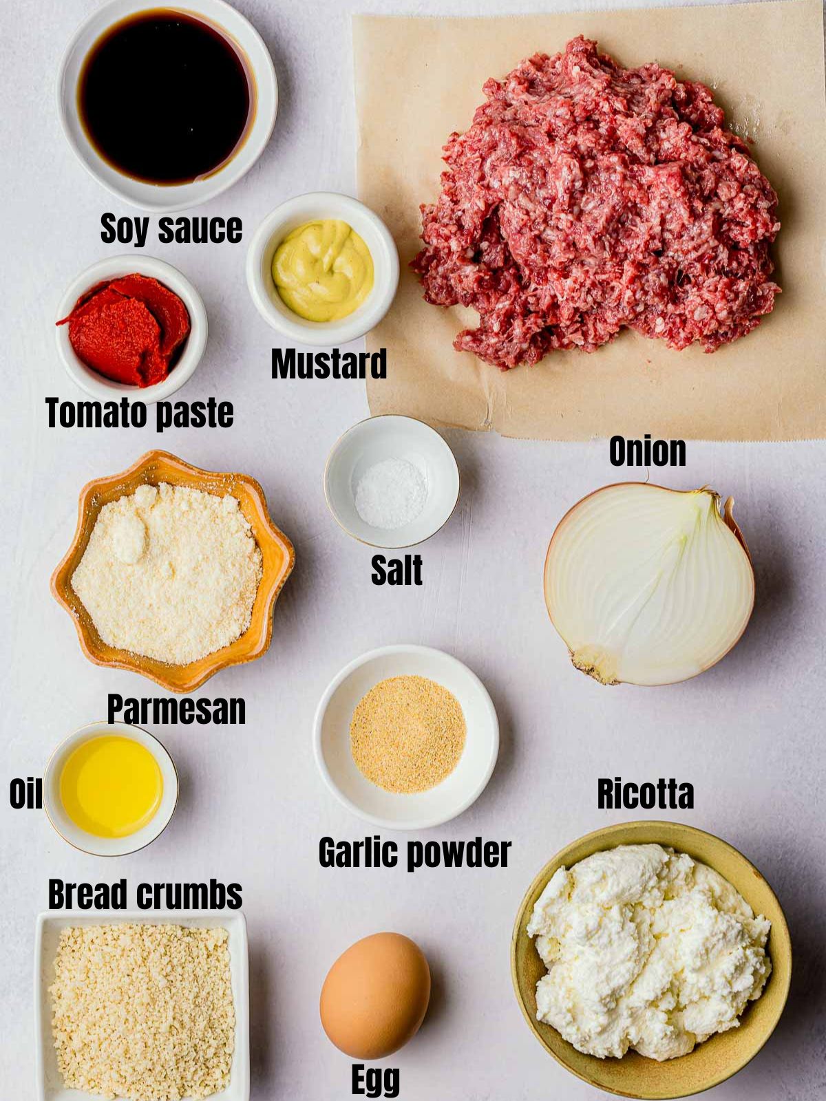 ingredients for sous vide meatballs on a white background in dishes