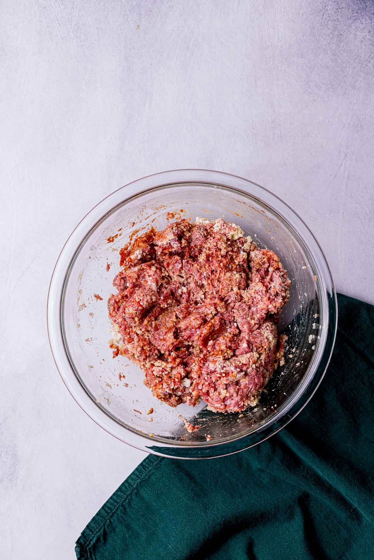 raw ground meat with seasonings in a bowl