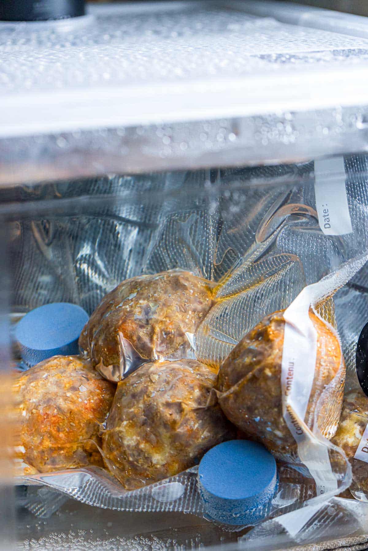 meatballs being cooked in a water bath in a bag