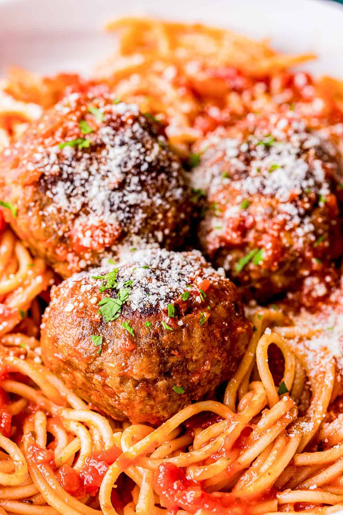 3 meatballs on a pile of spaghetti 