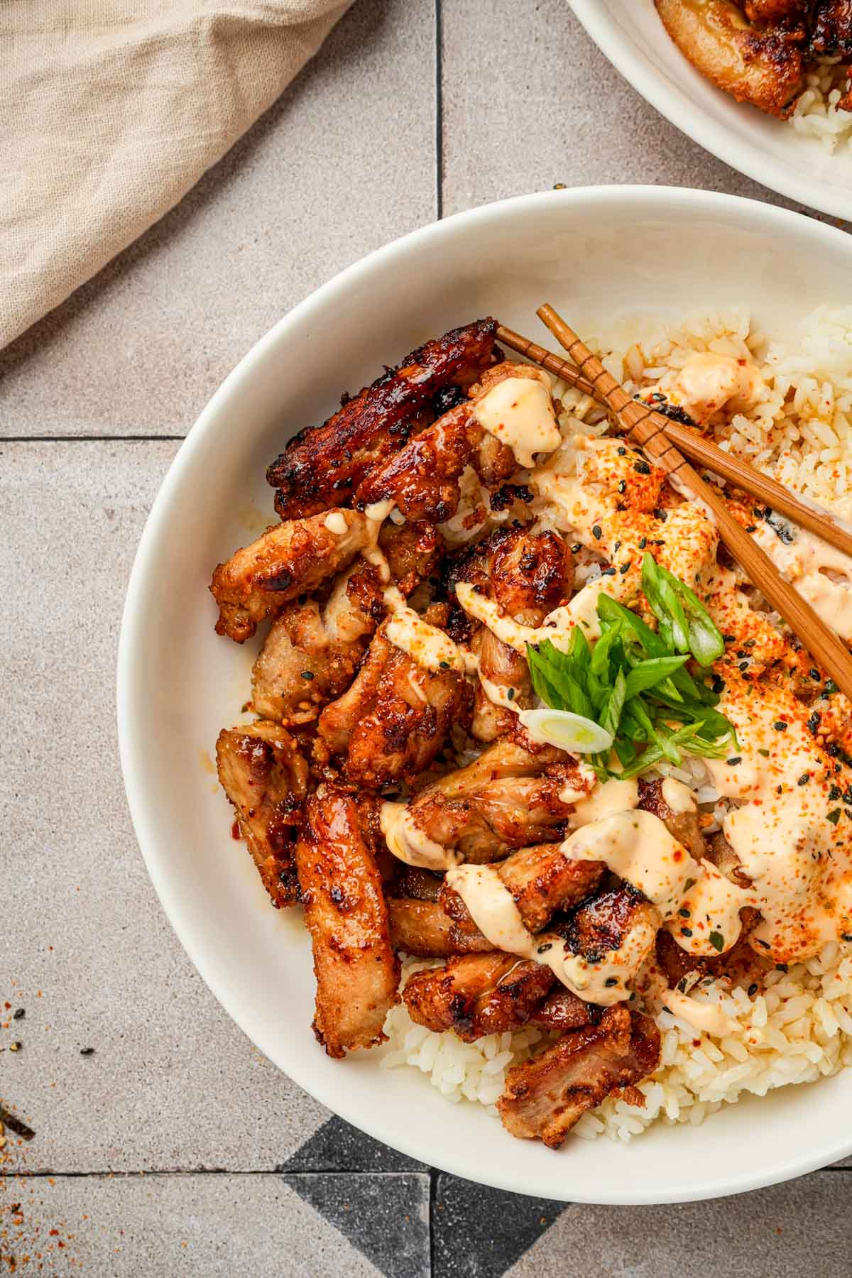 Japanese fried chicken in a bowl with rice and green onions