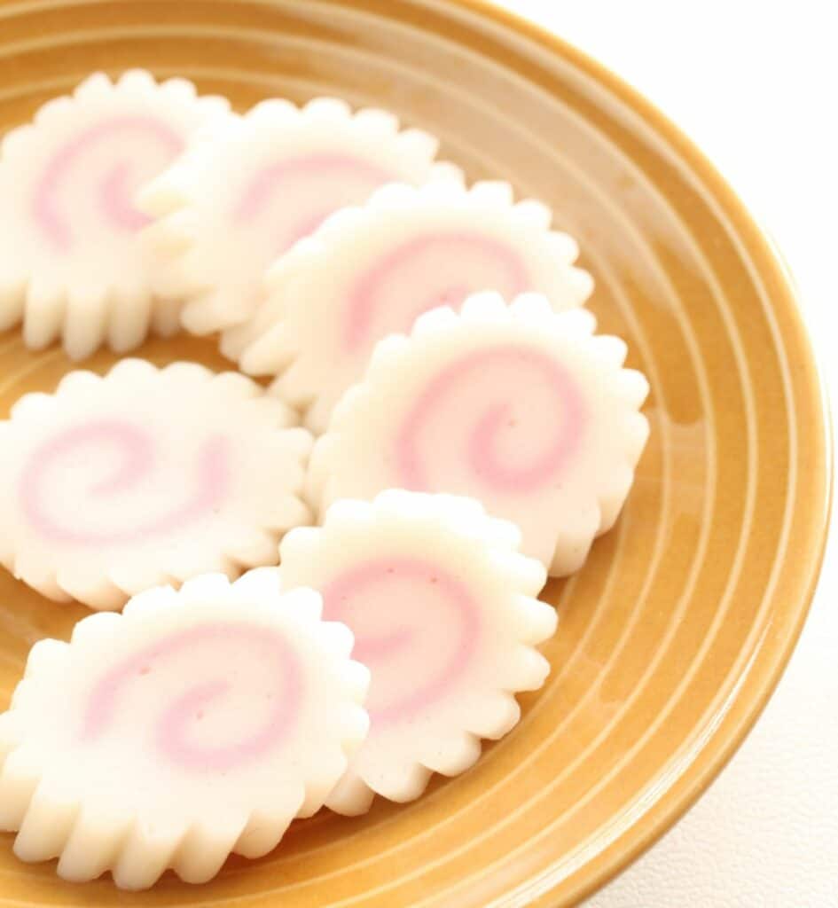 a plate of pink and white sliced japanese fish cake