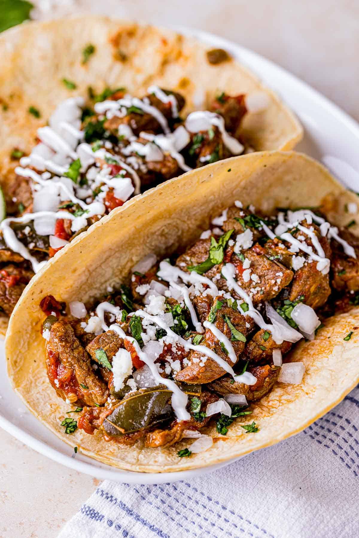 a tortilla filled with carne picada (braised beef) and garnishes