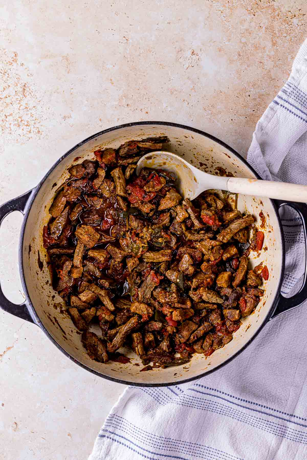 beef with vegetables cooking in a pot