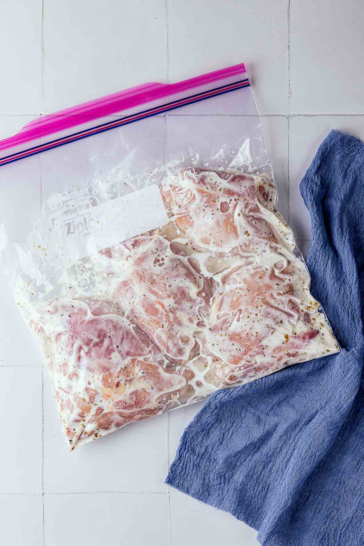 raw chicken in marinade in a ziplock bag