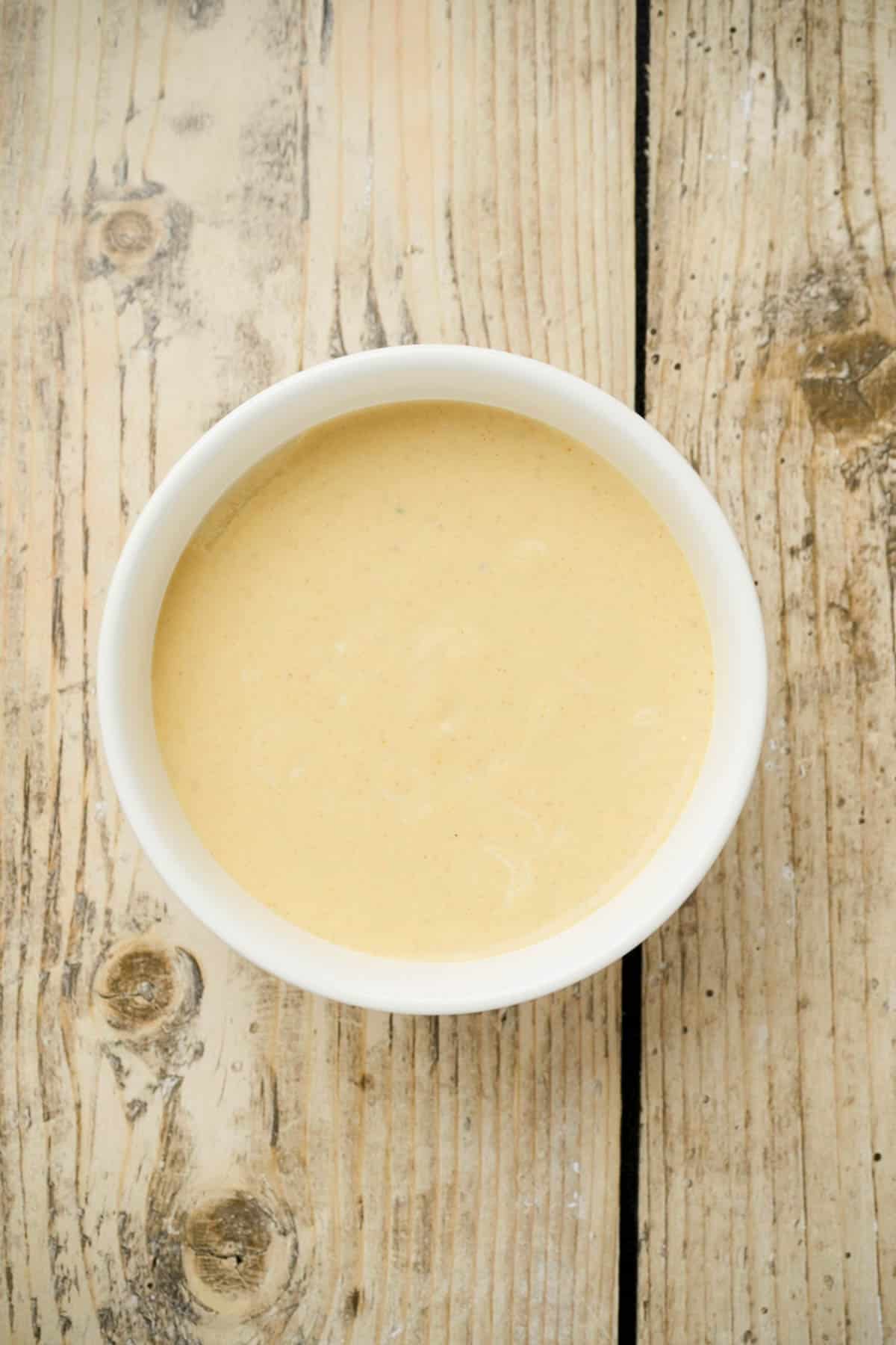 yellow sauce in a white bowl