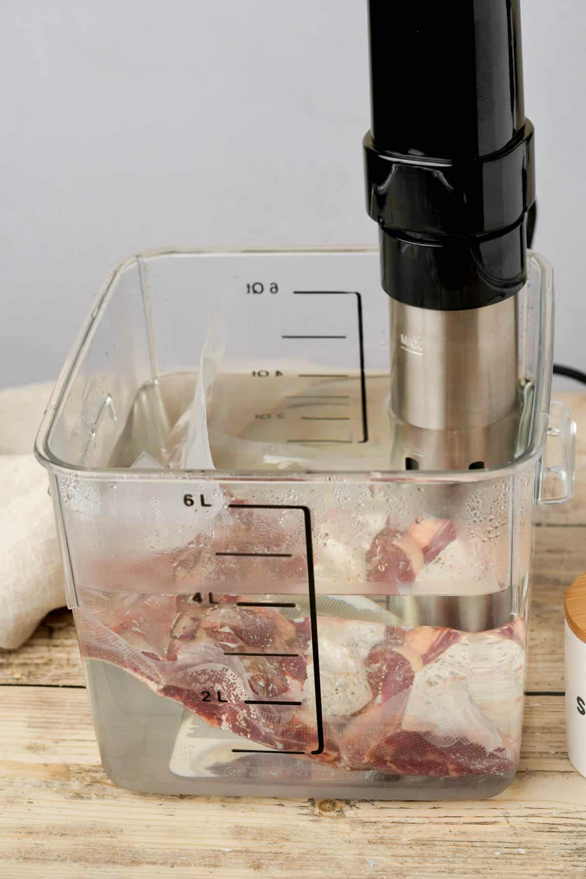 beef cooking in a sous vide water bath