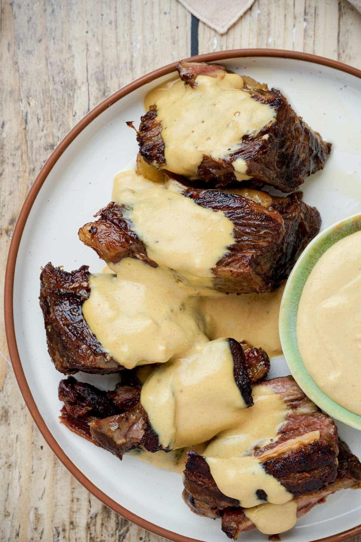 a plate of sous vide boneless short ribs with mustard sauce