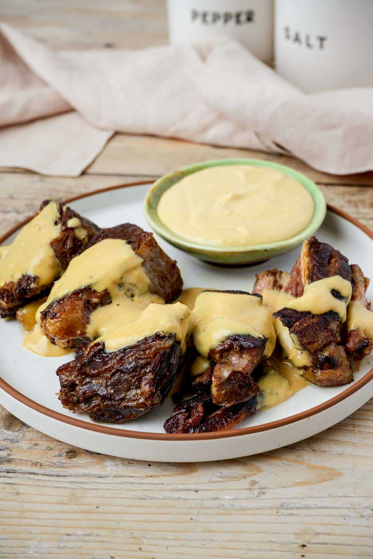 boneless beef short ribs on a plate with sauce