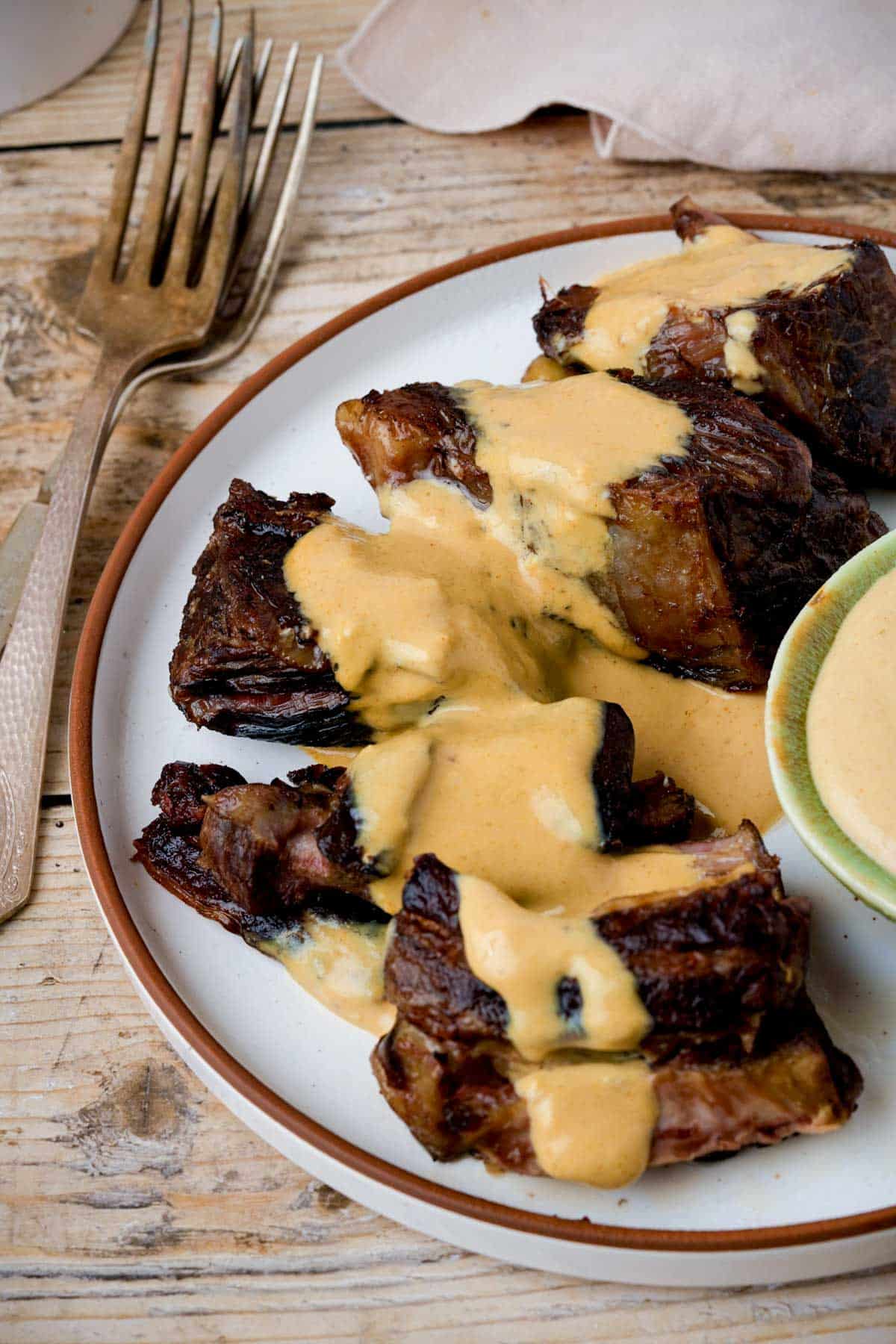 browned beef on a plate with dijon mustard sauce