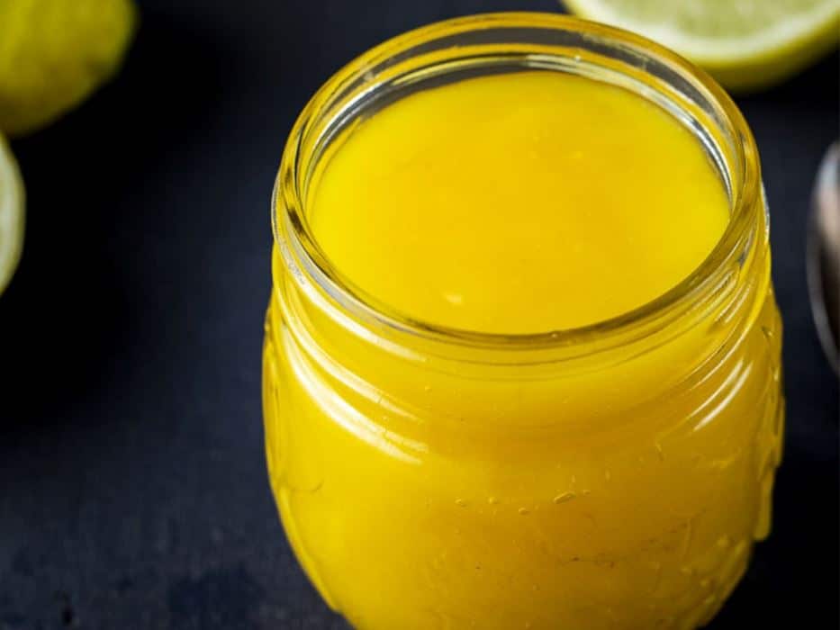 a glass jar of yellow lime curd.
