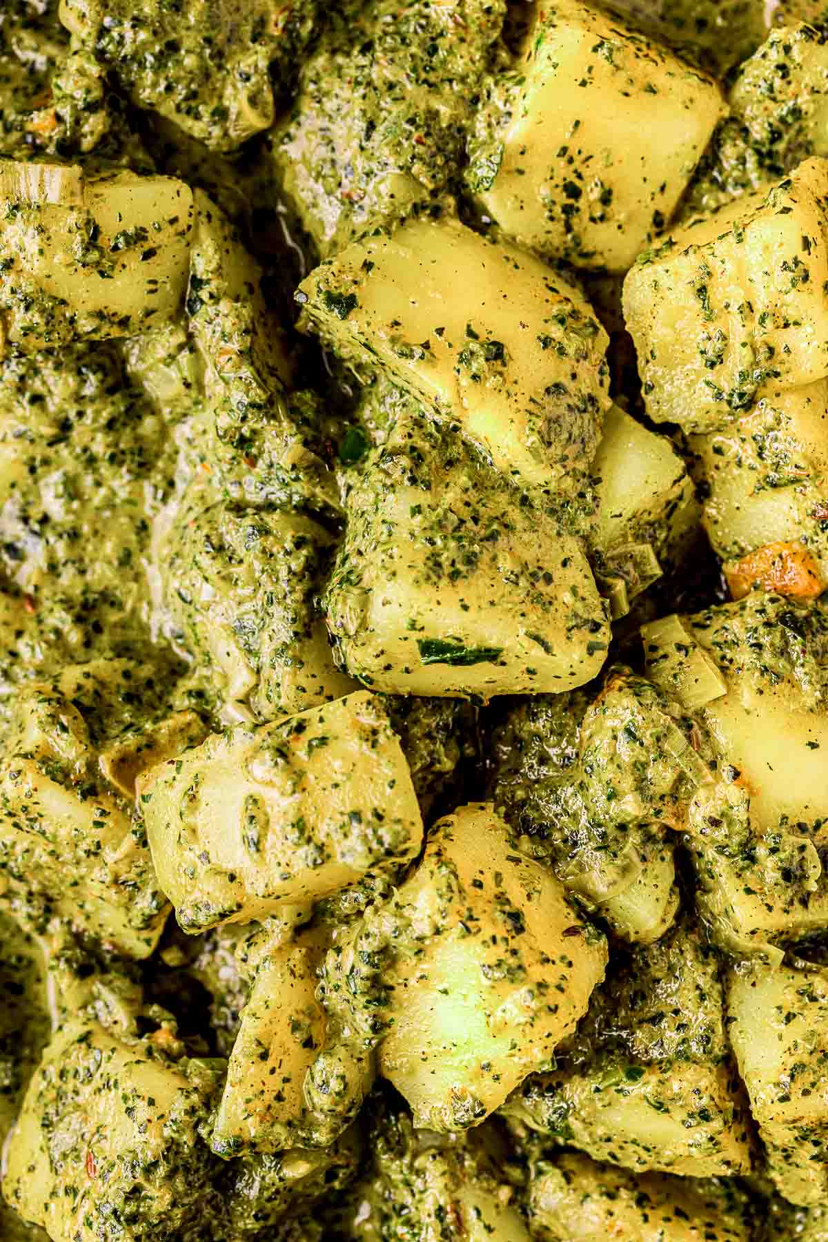 potatoes covered in a green/yellow sauce