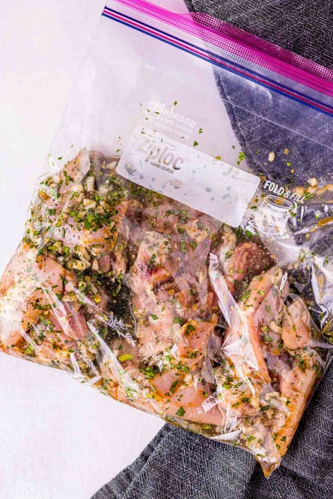 raw chicken in marinade in a plastic bag