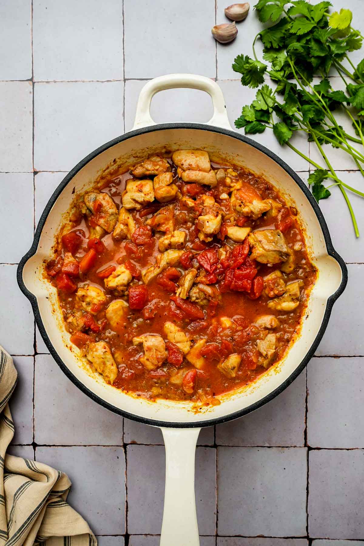 chicken and tomatoes in a skillet.