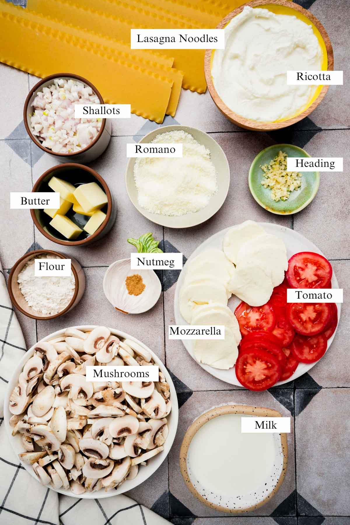 ingredients for mushroom lasagna on a board.