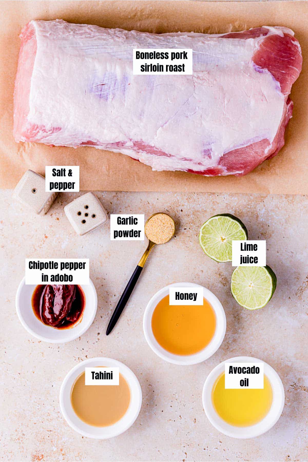 ingredients for sous vide pork sirloin roast on a surface with text labels.