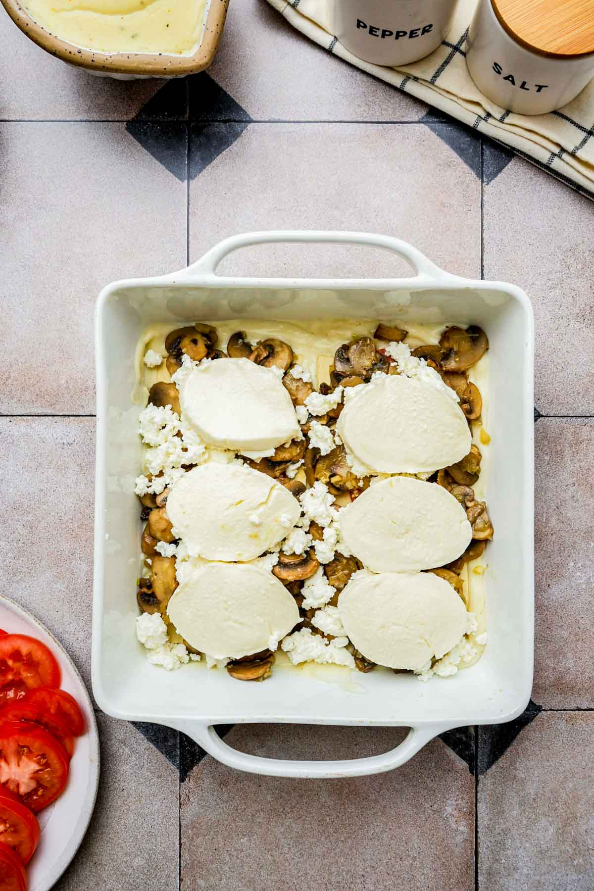 layers on lasagna in a baking dish.