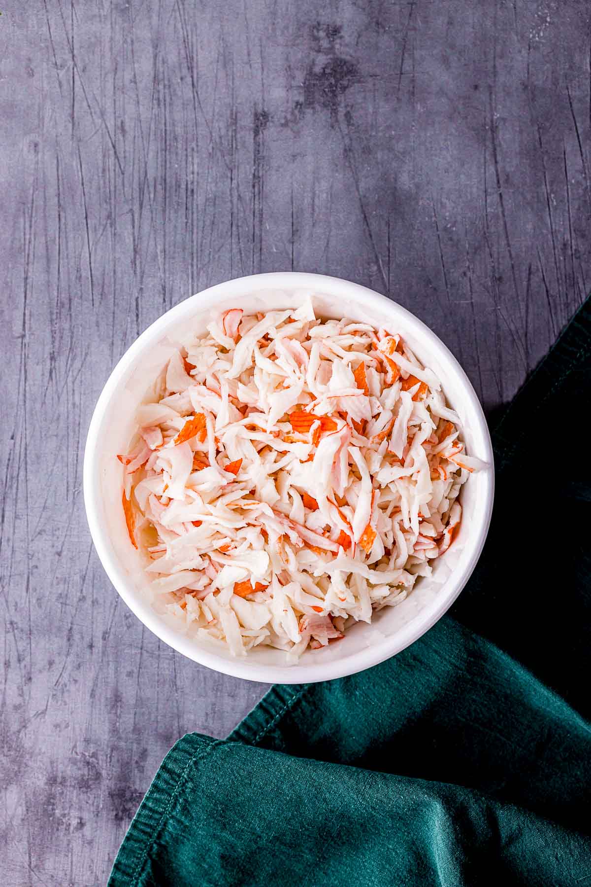 a bowl of shredded imitation crab meat