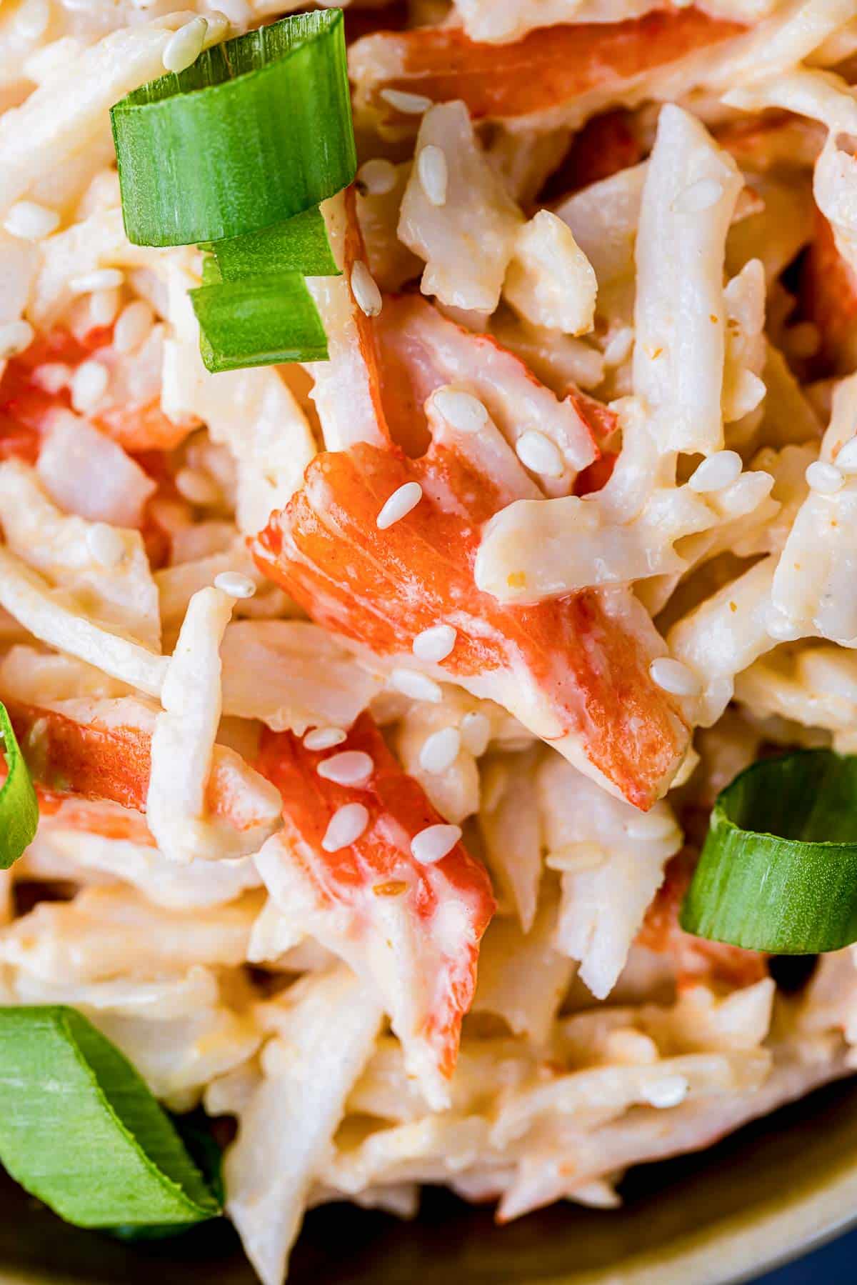 imitation crab meat pieces with sauce and green onions