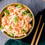 a bowl of sushi crab mix and chopsticks on the side