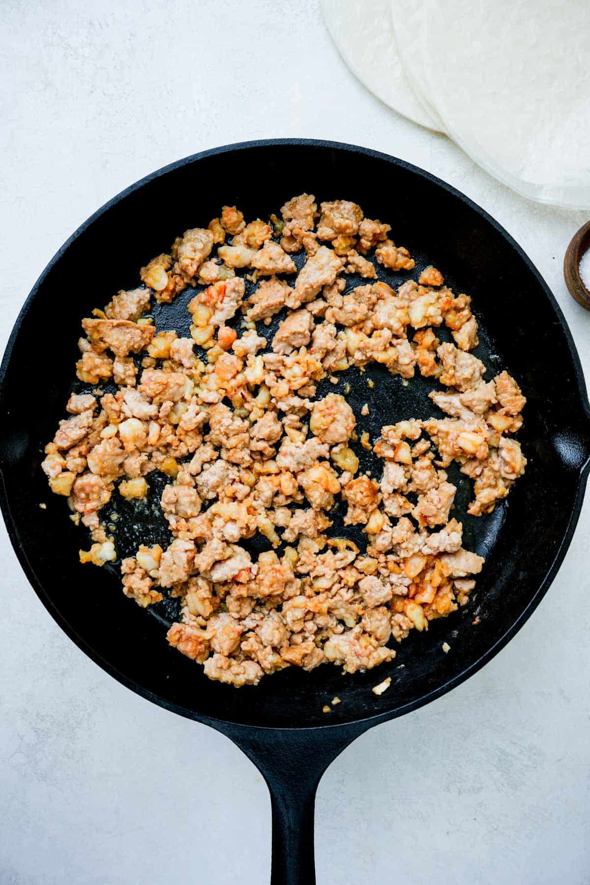 ground pork cooking in a skillet.