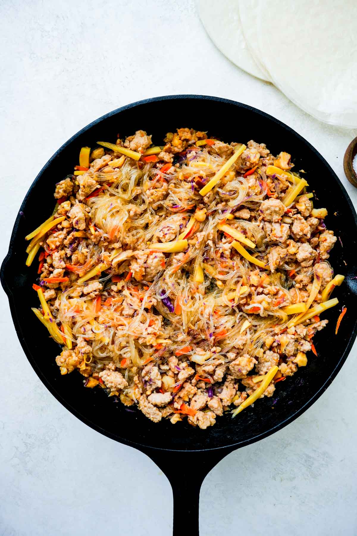 ground pork and vegetables cooking in a skillet.