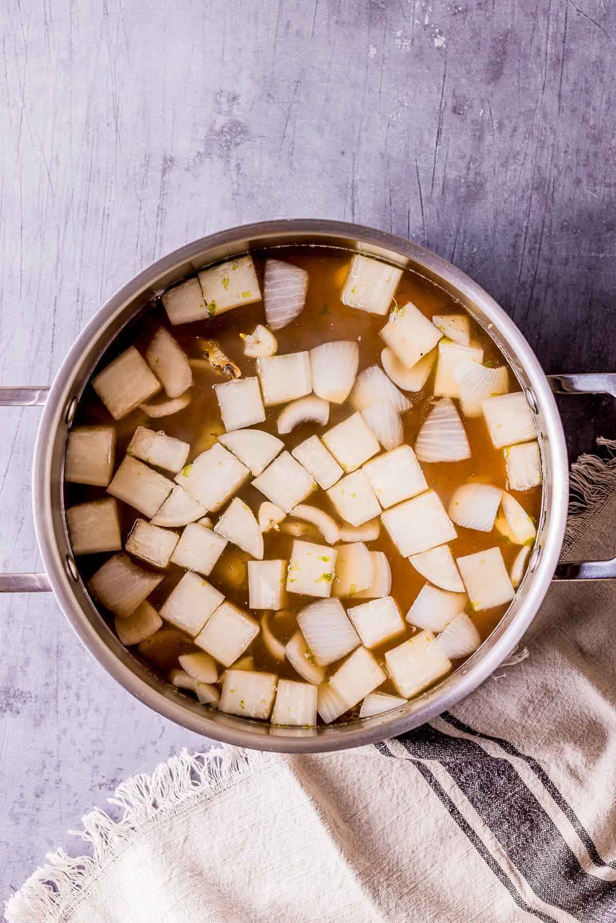 white cubes cooking in broth.