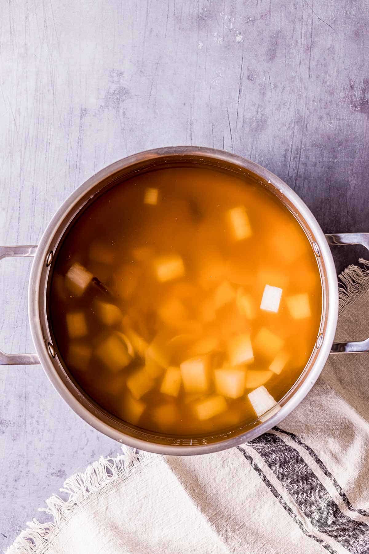 broth with white cubes in it.