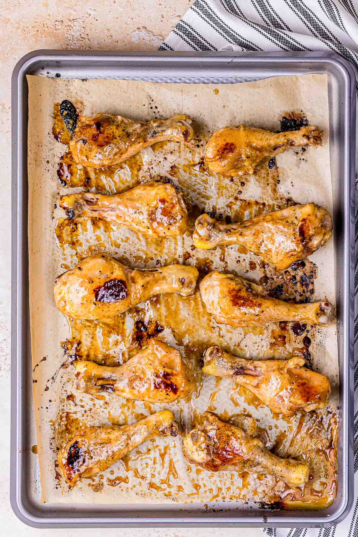 roasted chicken legs on a baking sheet.