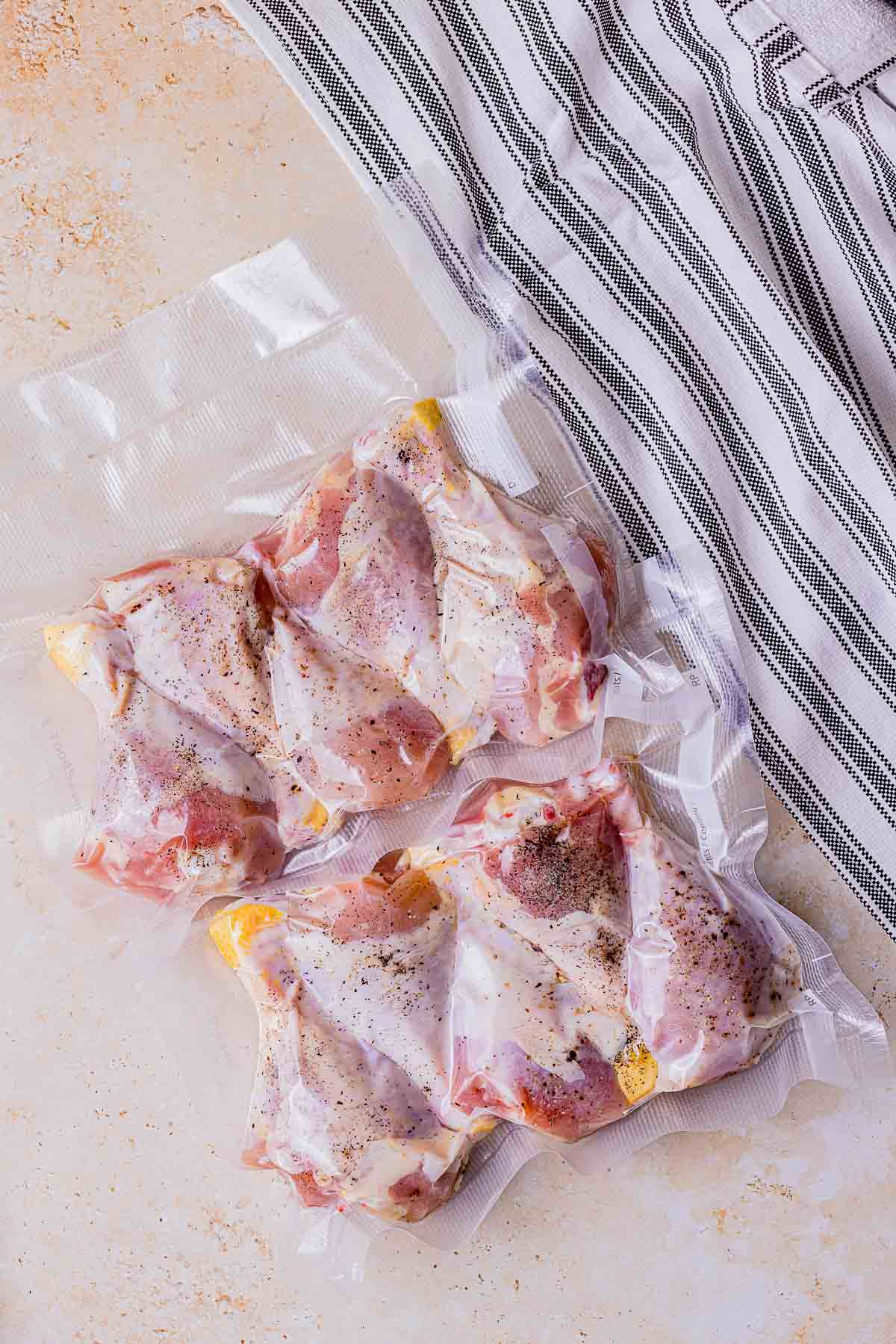 raw chicken legs in a vacuum seal bag.