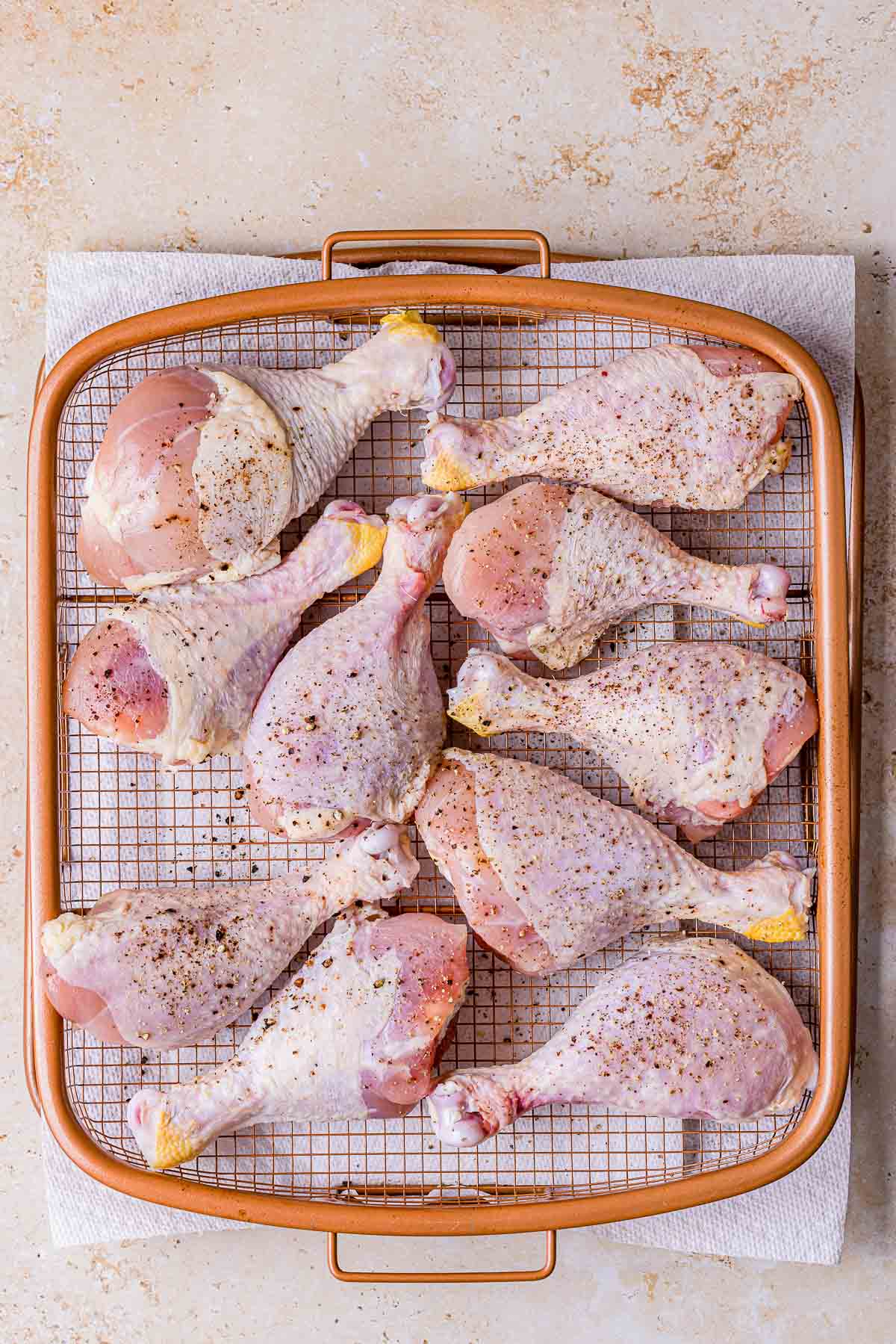 raw chicken legs with salt and pepper.