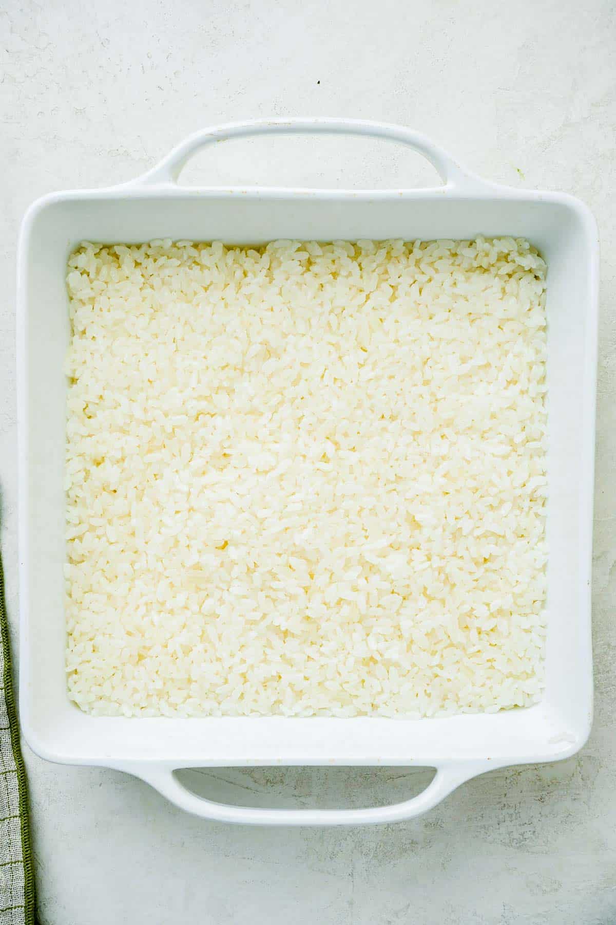 cooked rice in a square baking dish.