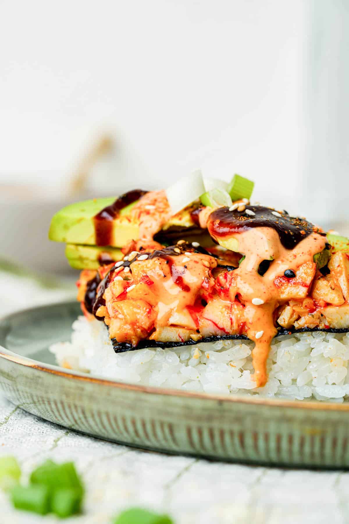 sushi crab bake with orange sauce on a plate.