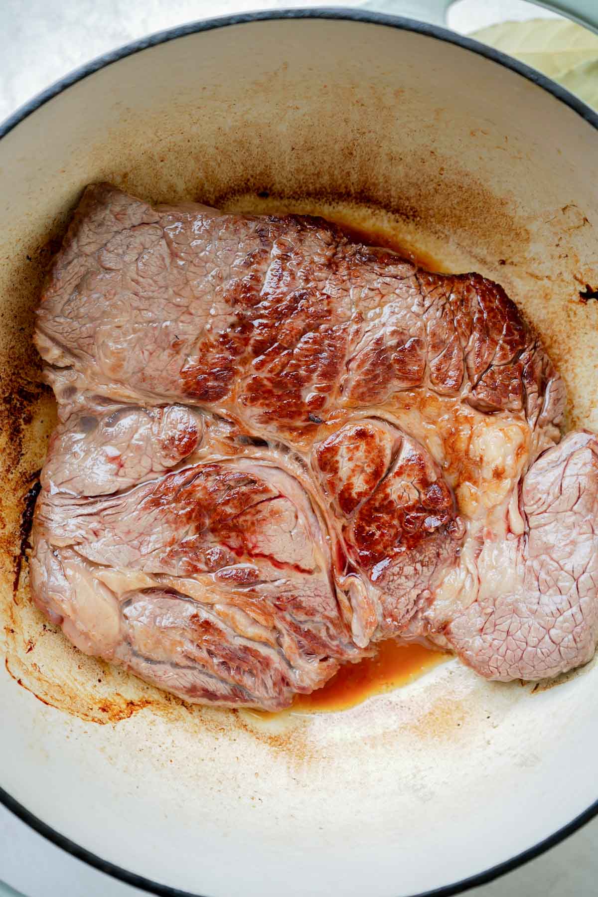 a chuck roast browning in a pot.