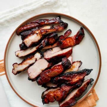 sliced of char sui on a plate.